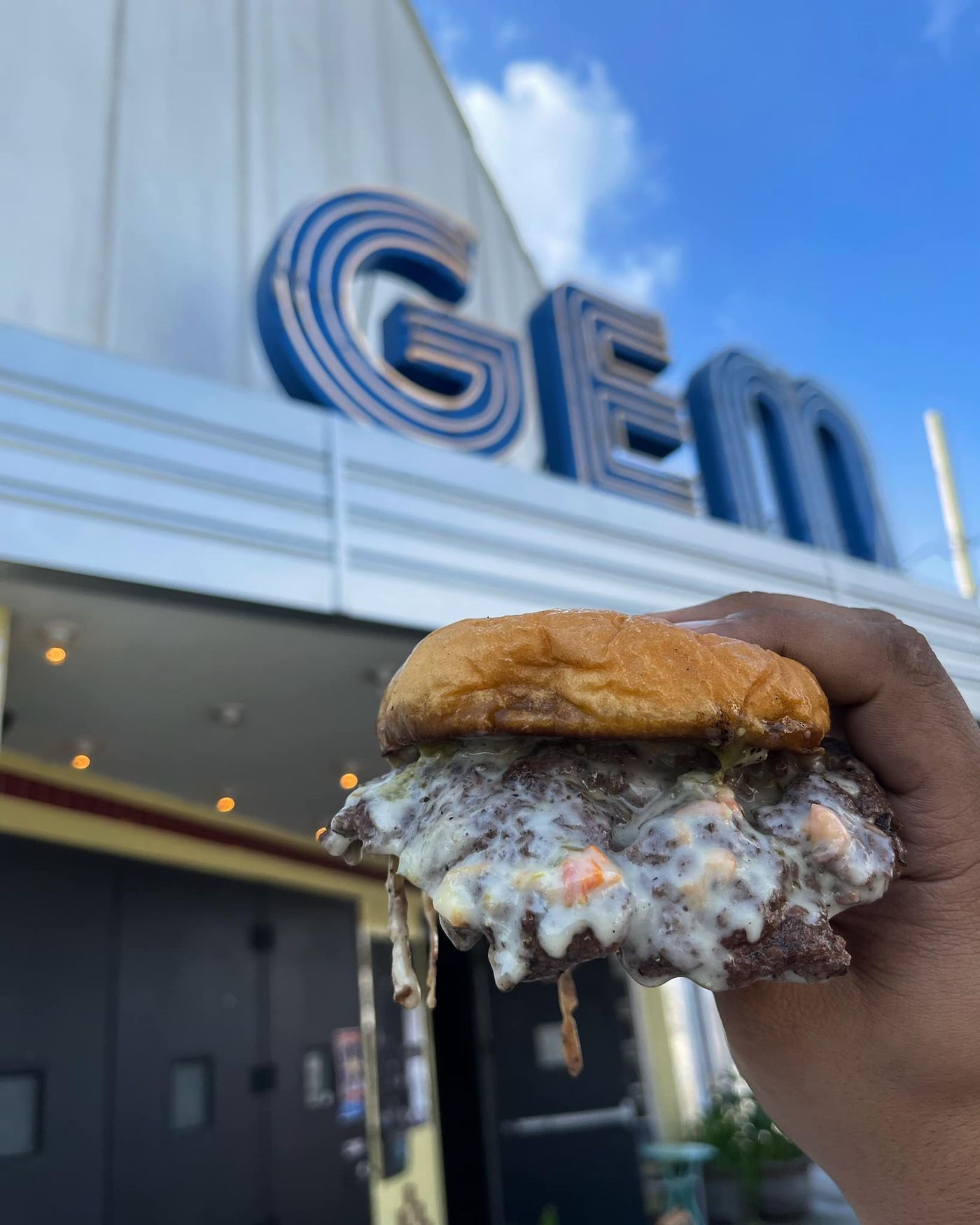 image of queso burger in front of Zony Mash Brewery
